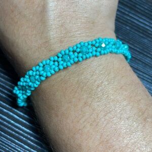 Handmade turquoise colored flower bracelet.